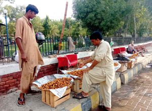 A vendor displays verities of Dates on roadside to attract the customers in the city.