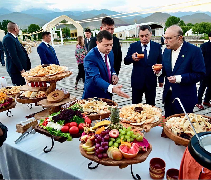 President Asif Ali Zardari tastes traditional Kyrgyz cuisine during a cultural reception hosted in his honour at the Rukh Ordo Cultural Center