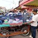 A roadside vendor displaying jeans to attract the customers at Makki Shah road