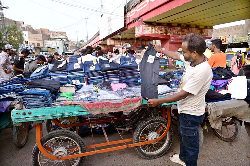 A roadside vendor displaying jeans to attract the customers at Makki Shah road