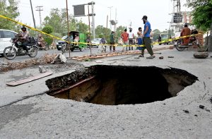 A view of Main Blvd Allama Iqbal Town Road collapsed due to heavy rain in the city. APP/MTF/ABB
