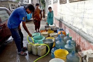 Residents collect water from a borehole for drinking and household use amid a water shortage in the city