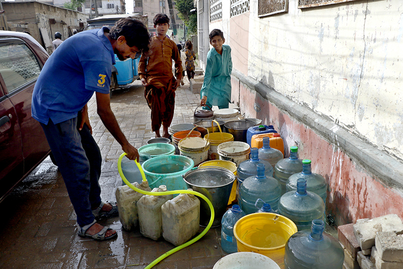 Residents collect water from a borehole for drinking and household use amid a water shortage in the city