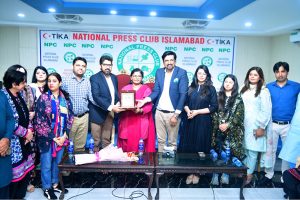Principal Information Officer Raisa Adil being presented with a shield at the National Press Club by President Abdul Razzaq Sial and Finance Secretary Abid Abbasi on her arrival at the National Press Club.