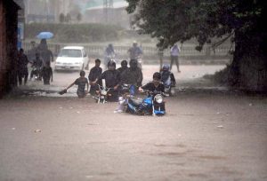 Vehicles wade through a flooded road following heavy monsoon rain in the city.