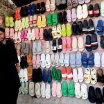 A vendor displaying shoes to attract the customers at old bus stand road