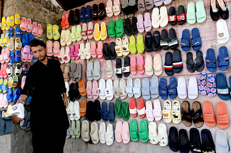 A vendor displaying shoes to attract the customers at old bus stand road
