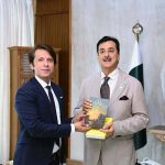 Acting President Syed Yousuf Raza Gilani receiving books from Mr Rahman Faras at Aiwan-e-Sadr