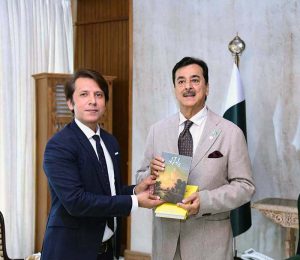 Acting President Syed Yousuf Raza Gilani receiving books from Mr Rahman Faras at Aiwan-e-Sadr