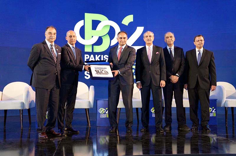 Saad Ur Rahman Khan, Executive Committee Member, PBA and Managing Director of the ⁠Pakistan Kuwait Investment Company, presents a souvenir to Minister of State for Finance & Revenue Bilal Azhar Kayani during the Pakistan Banking Summit 2026 in Karachi. Chairman, Pakistan Banks Association, Zafar Masud; Vice Chairman, PBA, and CEO, Faysal Bank, Yousaf Hussain; Chairman, Steering Committee, Pakistan Banking Summit, and President & CEO, Bank Alfalah, Atif Bajwa; and CEO & Secretary General, PBA, Muneer Kamal are also present on stage