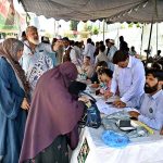 Voters are receiving their voting numbers from polling camps set up by different political parties at polling stations during the second phase of the Azad Jammu and Kashmir (AJK) Legislative Assembly elections