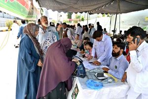 Voters are receiving their voting numbers from polling camps set up by different political parties at polling stations during the second phase of the Azad Jammu and Kashmir (AJK) Legislative Assembly elections