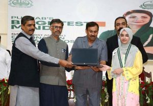 Chairman Board of Intermediate & Secondary Education (BISE) Faisalabad, Dr Rana Binyamin, presents a laptop to the overall first position holder of the Matriculation Examination 2026 during a prize distribution ceremony held at the BISE Auditorium.