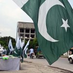 Pakistani flags and Jashn-e-Azadi items displayed at a roadside stall on Tipu Road as part of Independence Day celebrations