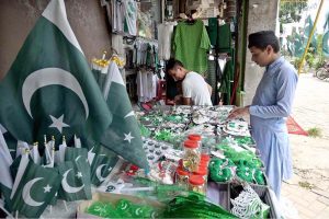 Seasonal vendors display national flags and Independence Day-themed items at a roadside stall in Aabpara Market ahead of August 14 celebrations.