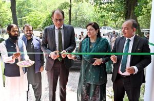 Federal Secretary Information and Broadcasting, Ashfaq Ahmad Khalil, cuts a ribbon to inaugurate a painting exhibition organized by the Directorate of Electronic Media and Publications (DEMP) in connection with Independence Day celebrations, at the Information Services Academy.