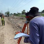 A survey team takes measurements as work continues on the extension and rehabilitation of the Islamabad Expressway service road near Faizabad interchange