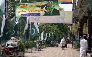 Seasonal vendors display national flags and Independence Day-themed items at a roadside stall in Aabpara Market ahead of August 14 celebrations.