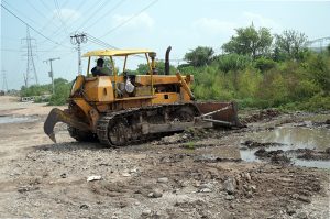 Work in progress as heavy machinery is used for the construction of a six-lane road along the east side of Islamabad Expressway, in the Federal Capital