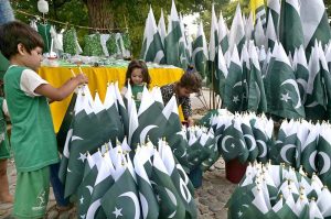 Seasonal vendors display national flags and Independence Day-themed items at a roadside stall in Aabpara Market ahead of August 14 celebrations.