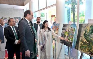 Federal Secretary Information and Broadcasting, Ashfaq Ahmad Khalil, cuts a ribbon to inaugurate a painting exhibition organized by the Directorate of Electronic Media and Publications (DEMP) in connection with Independence Day celebrations, at the Information Services Academy.