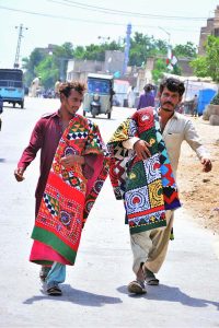 Vendors are displaying handmade Sindhi ralli (quilts) to attract customers while shuttling along Jail Road.