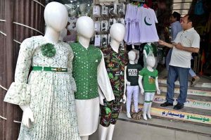 Seasonal vendors display national flags and Independence Day-themed items at a roadside stall in Aabpara Market ahead of August 14 celebrations.
