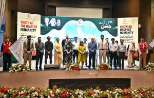 Chairperson of the Pakistan Red Crescent Society (PRCS), Farzana Naek, poses for a group photograph with participants during a seminar marking International Youth Day and International Humanitarian Law (IHL) Day at PRCS