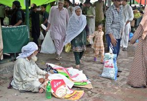 Labourers with handcarts wait for customers to carry their luggage at the weekly Sunday Bazaar in Aabpara, Federal Capital
