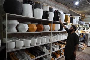 A vendor displays huge size plant pots to attract customers at H-9 Nursery in the Federal Capital