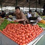 Vendors are arranging and displaying vegetables on their stalls to attract the customers at weekly Sunday Bazaar, Peshawar Morr in the Federal Capital