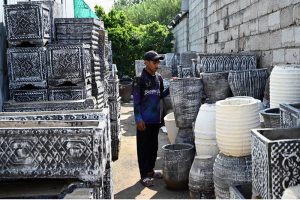A vendor displays huge size plant pots to attract customers at H-9 Nursery in the Federal Capital