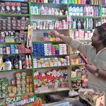 A shopkeeper arranging and displaying different items at his shop in Ghouri Town to attract the customers