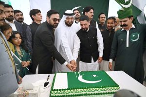 Acting Consul General of Pakistan in Dubai, Mr. Fawad Ali Khan, cuts the Independence Day cake in the presence of officers, officials, members of the Pakistani community and guests at the Consulate General of Pakistan