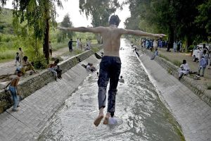 Youngersters are enjoying and playing in water of cannel channel made from of Khanpur dam in KPK most famous picnic point for tourists