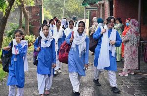 Students arrive at school on the first day after summer vacation in the Provincial Capital.