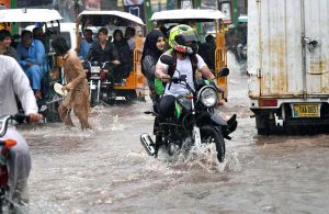 Children enjoying playing in the rain during the monsoon downpour; this spell of rain has broken the intense heatwave.