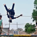 Youngsters enjoying jumping on the jumping jack at Mehar Ali Colony, Latifabad
