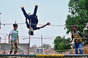 Youngsters enjoying jumping on the jumping jack at Mehar Ali Colony, Latifabad