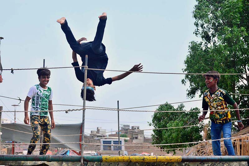 Youngsters enjoying jumping on the jumping jack at Mehar Ali Colony, Latifabad