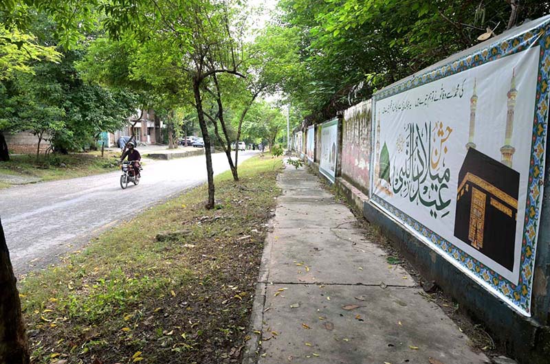 A poster is being displayed on the wall of a school in connection with the upcoming Eid Milad-un-Nabi (PBUH) in the Federal Capital
