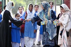 Students arrive at school on the first day after summer vacation in the Provincial Capital.