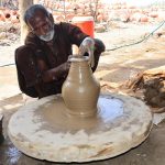 A craftsman busy in preparing clay-made stuff at his work place in Kumhar para