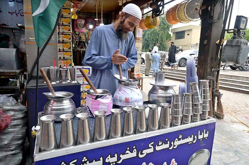A vendor preparing Beverage (Lassi) for the customers in a local market of Federal Capital