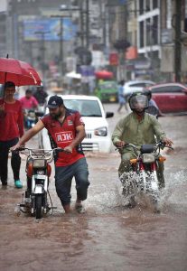 Children enjoying playing in the rain during the monsoon downpour; this spell of rain has broken the intense heatwave.