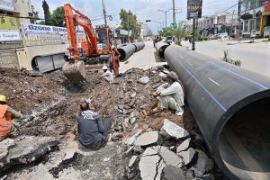 Workers are busy laying water pipelines with the help of an excavator on Saidpur Road during the city's water upgrading project