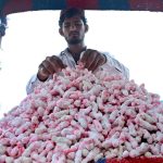 A roadside vendor displays traditional sweet treats, known as Tangri, to attract customers and earn a livelihood for his family
