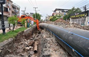 Workers are busy laying water pipelines with the help of an excavator on Saidpur Road during the city's water upgrading project