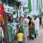 Citizens purchase green and white Independence Day merchandise including T-shirts, flags and accessories from stalls at H-9 weekly bazaar, as the nation gears up to celebrate Pakistan's 79th Independence Day on August 14