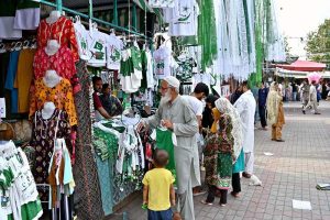 Citizens purchase green and white Independence Day merchandise including T-shirts, flags and accessories from stalls at H-9 weekly bazaar, as the nation gears up to celebrate Pakistan's 79th Independence Day on August 14